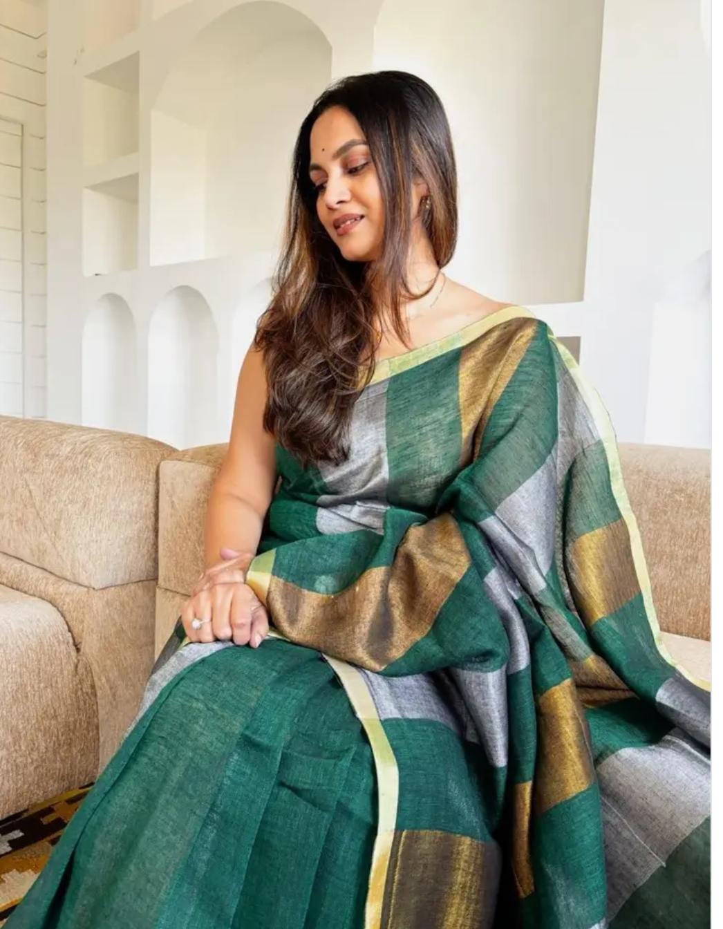 Color: Emerald Green Saree In A Modern Living Room